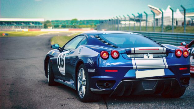 A picture of a Blue Ferrari at Silverstone race track, similar to one we have provided modern classic car finance for.